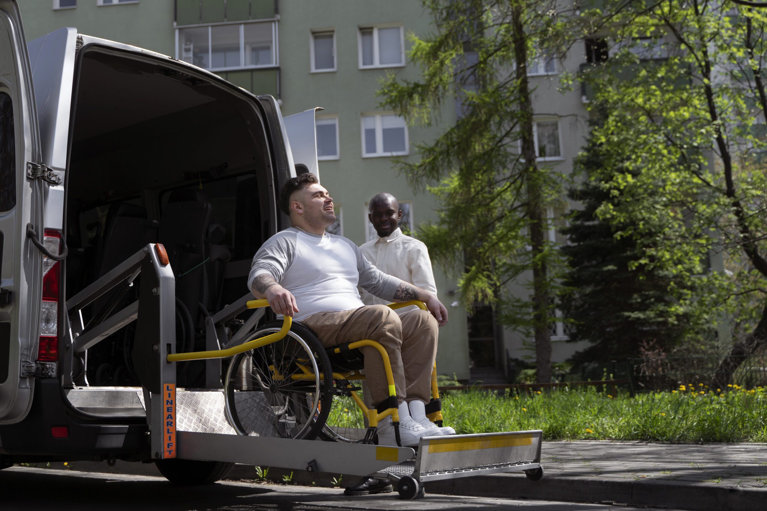 A JAX NEMT driver assisting a patient into an accessible vehicle